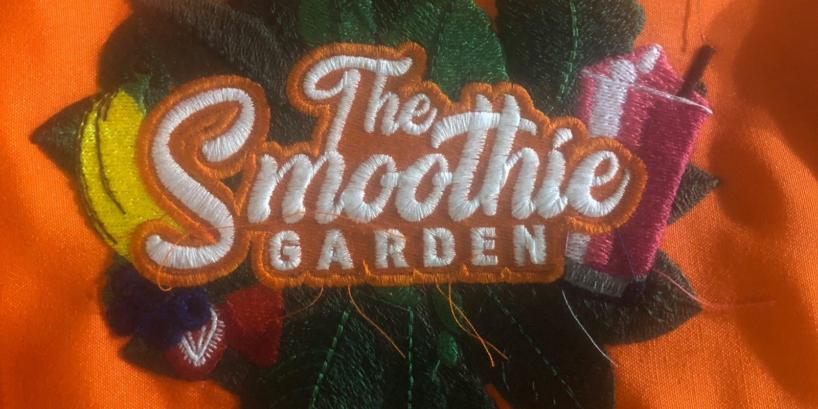 Digitized embroidery design on shirts and aprons for The Smoothie Garden, a Baltimore business